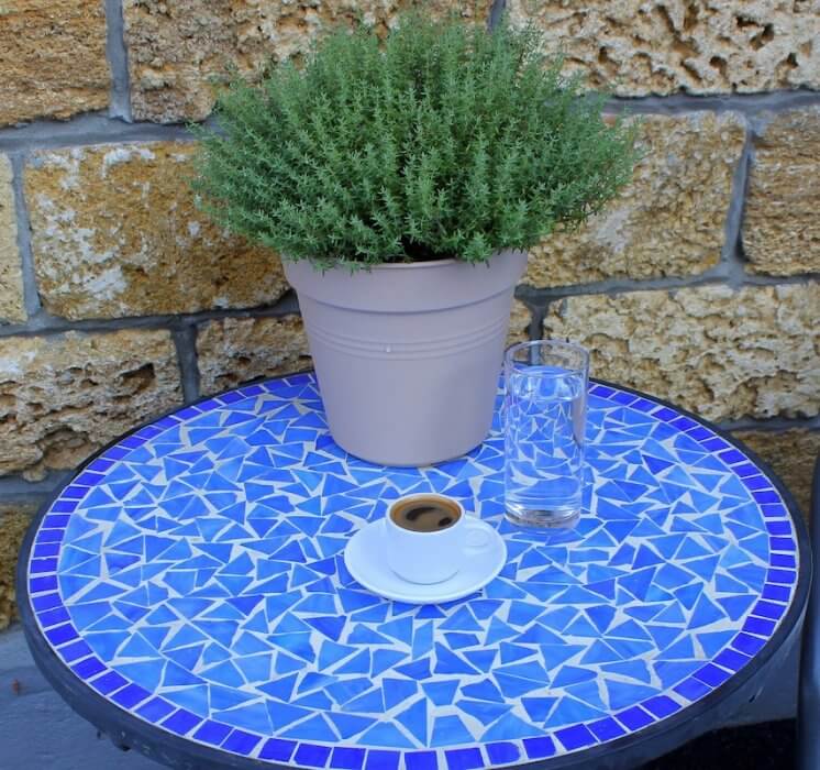 Greek coffee on a table with a rosemary plant