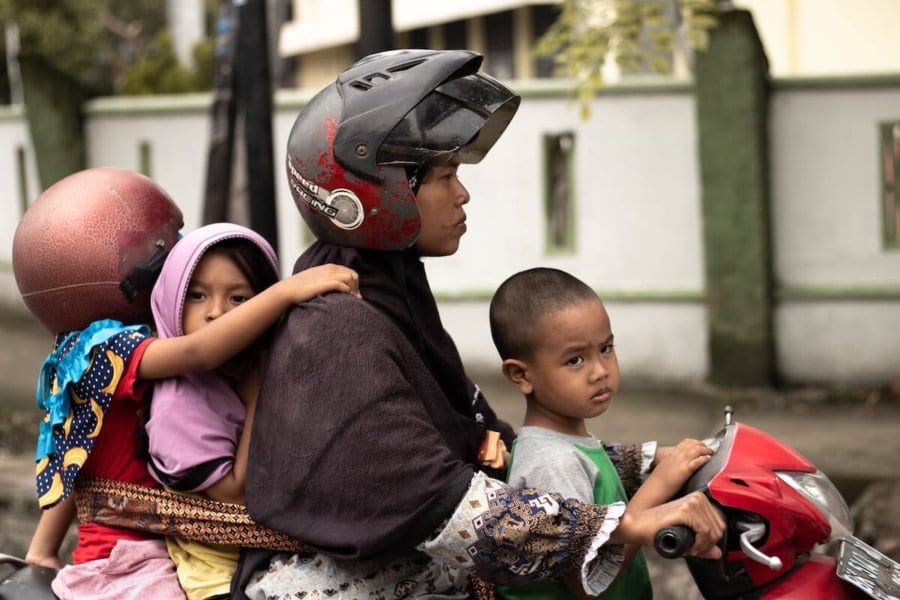 Kids without helmet on a scooter