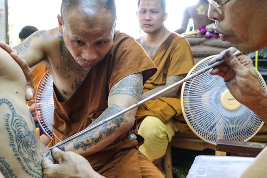 Monks making a traditional Sak Yant tattoo