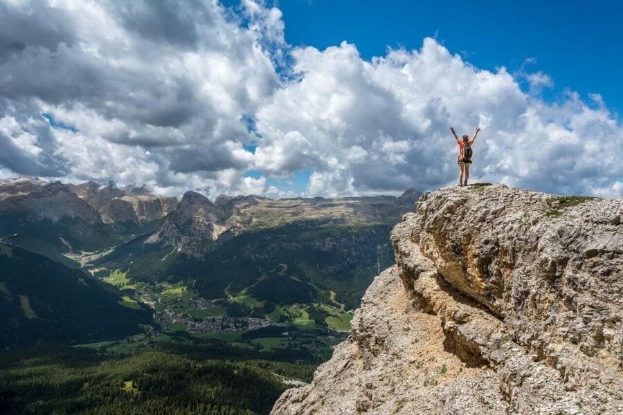 Hiker on top of mountain overlooking valley