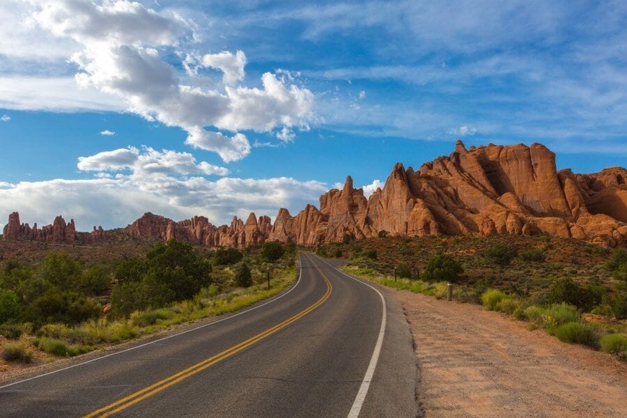 road leading to mountain with blue skies