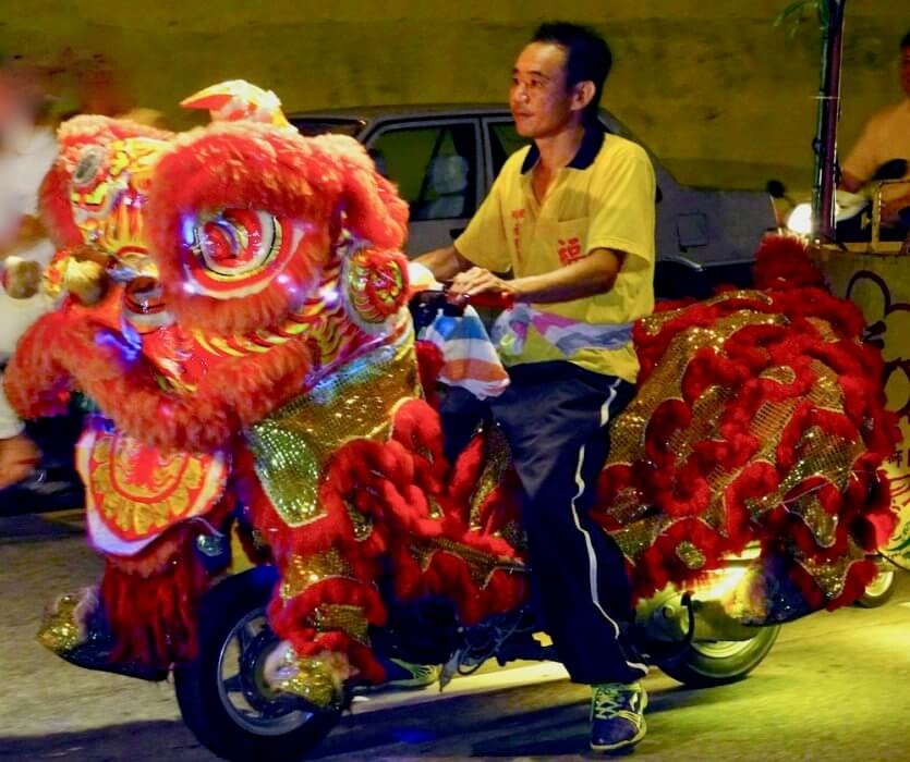 Man riding a Lion Dance scooter-reasons to visit Malaysia