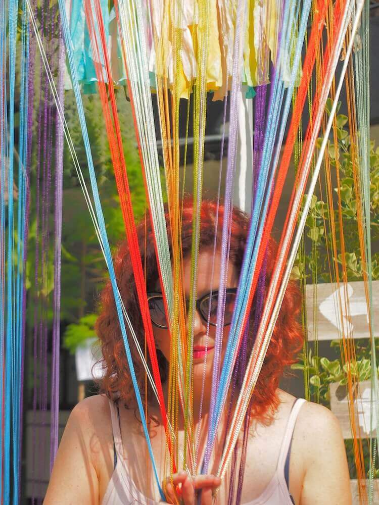 me peaking through colored string-you know your an expat when