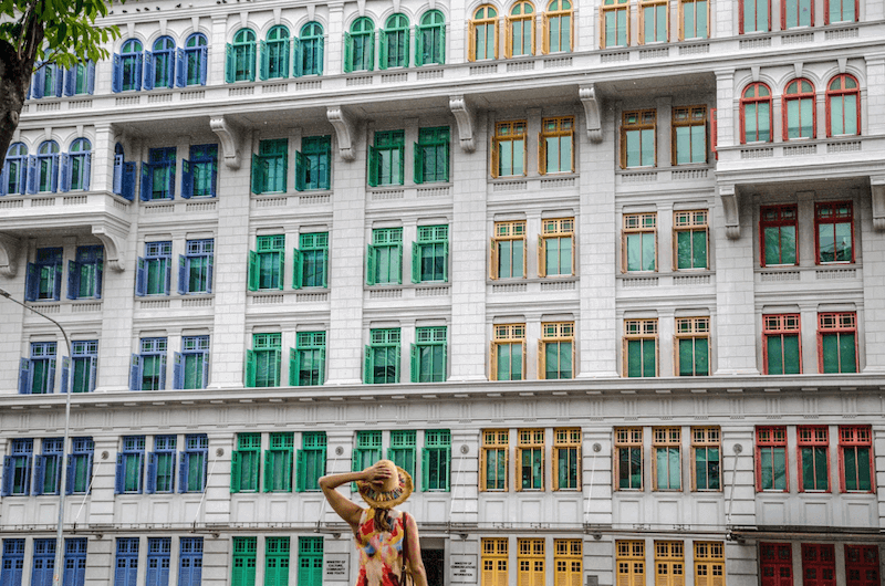 Girl looking at colorful building. How to be an Expat