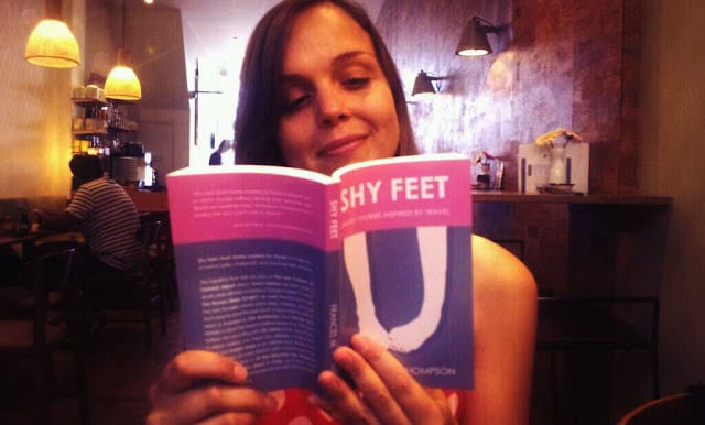 Woman reading a book titled Shy Feet