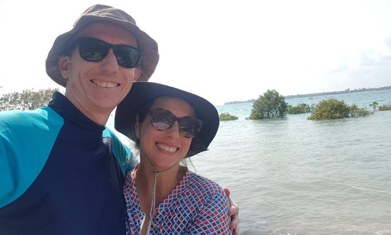 Couple wearing sun hats by the water