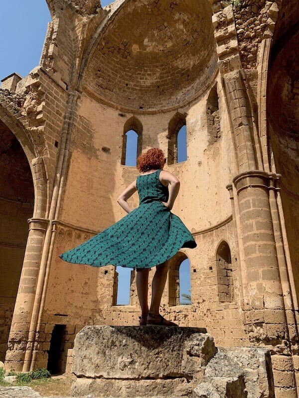 me standing in a ruin in a green dress