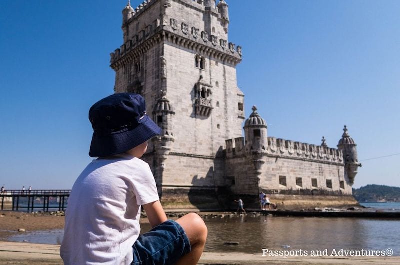 boy in blue hat looking at belem tower in Lisbon: multicultural kids