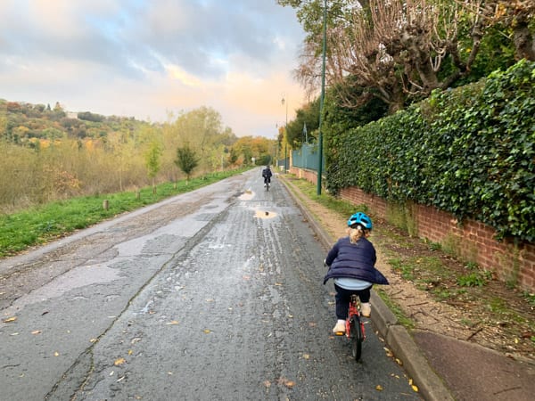 blond girl on a bicycle on a country road: multicultural kids