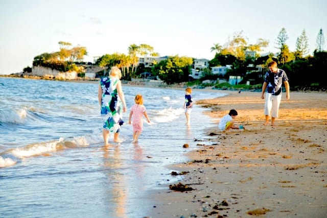 mom dad and 3 kids on the beach