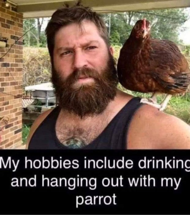 bearded man with chicken on shoulder