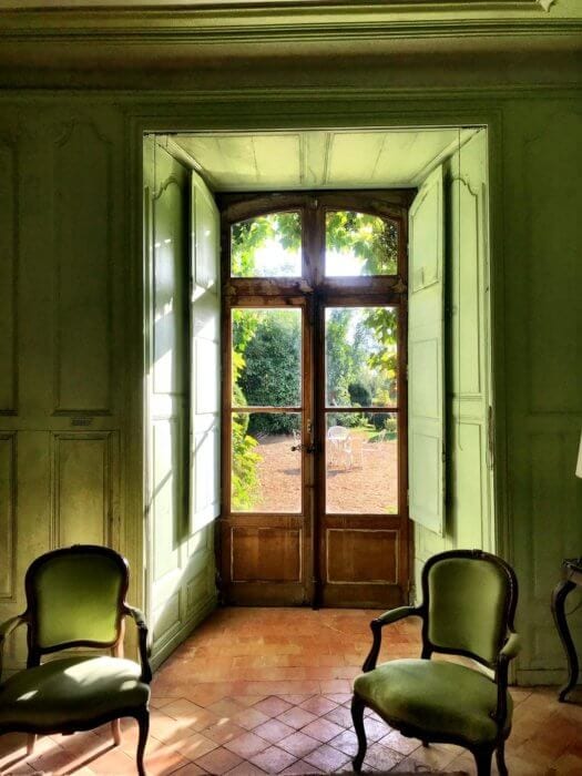 green walls and chairs looking out to gardenfrench lifestyle