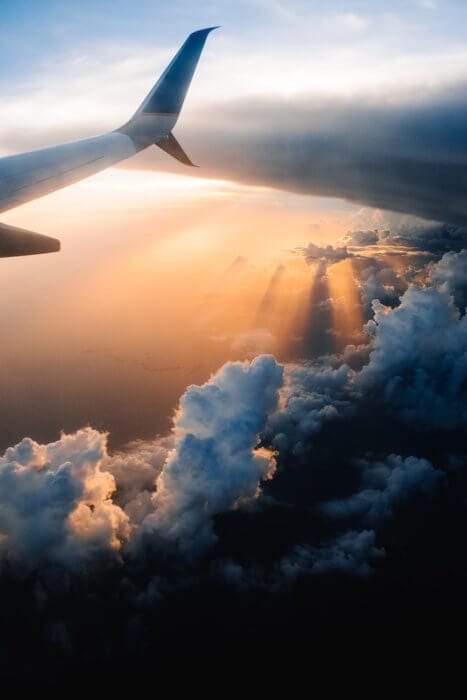 Sun rays and wing from a plane window. Moving to Malaysia