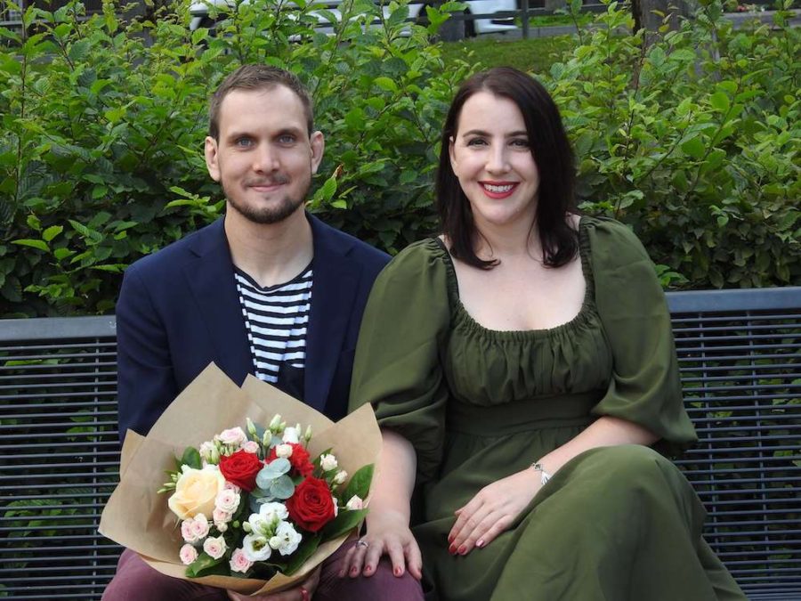 happy couple on a bench with flowers