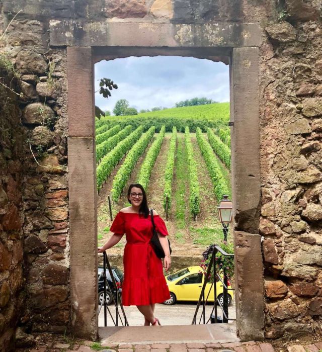 brunette in red dress in vineyard: living in strasbourg