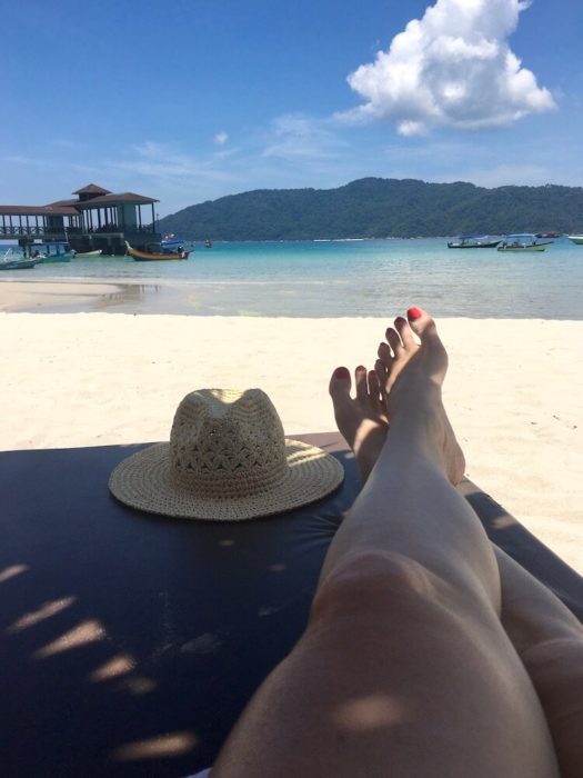 legs and hat on sun lounger: short getaway in malaysia