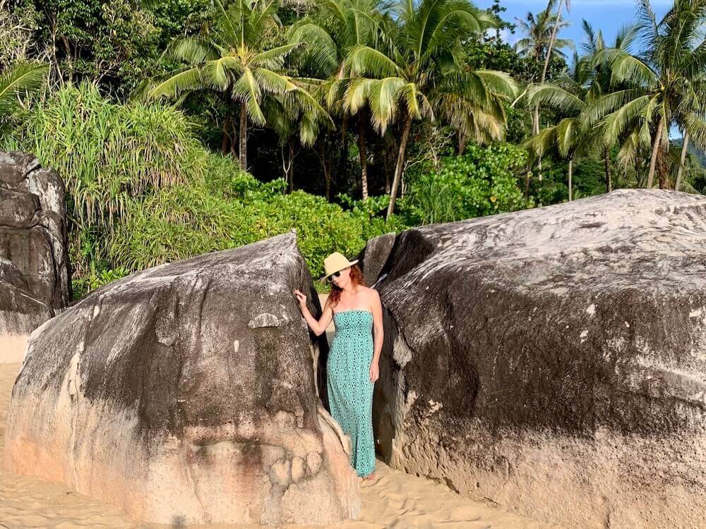 girl in turquoise dress between boulders