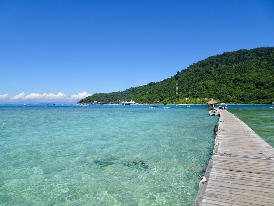 wooden pier with clear blue water