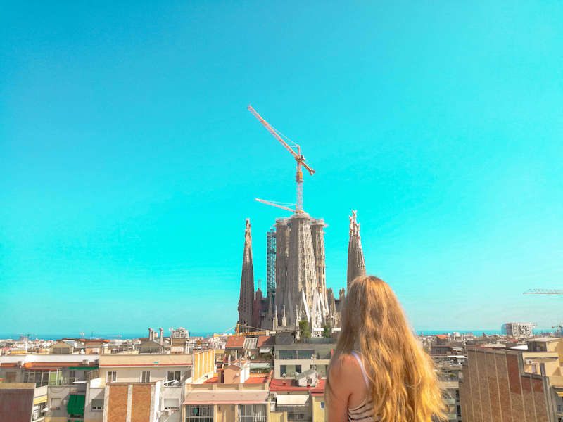 Vicky, a girl with long blonde hair looking over the Barcelona skyline.