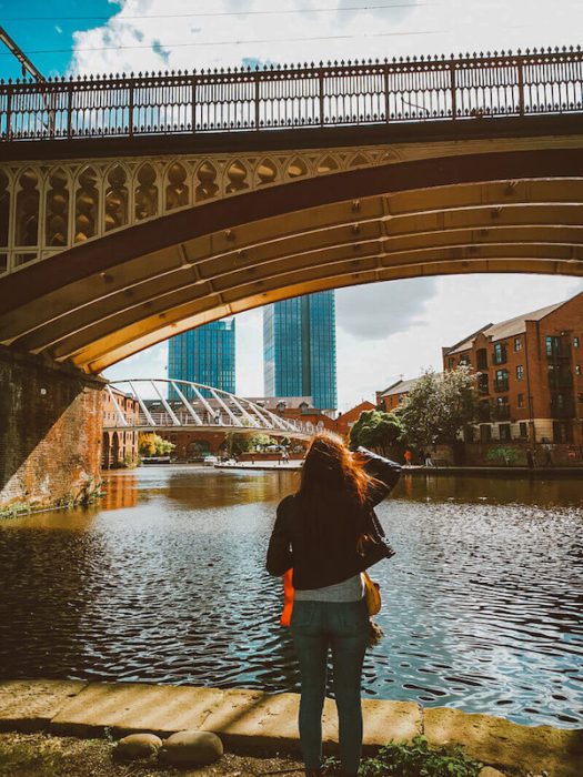 girl looking at river and Manchester bridge