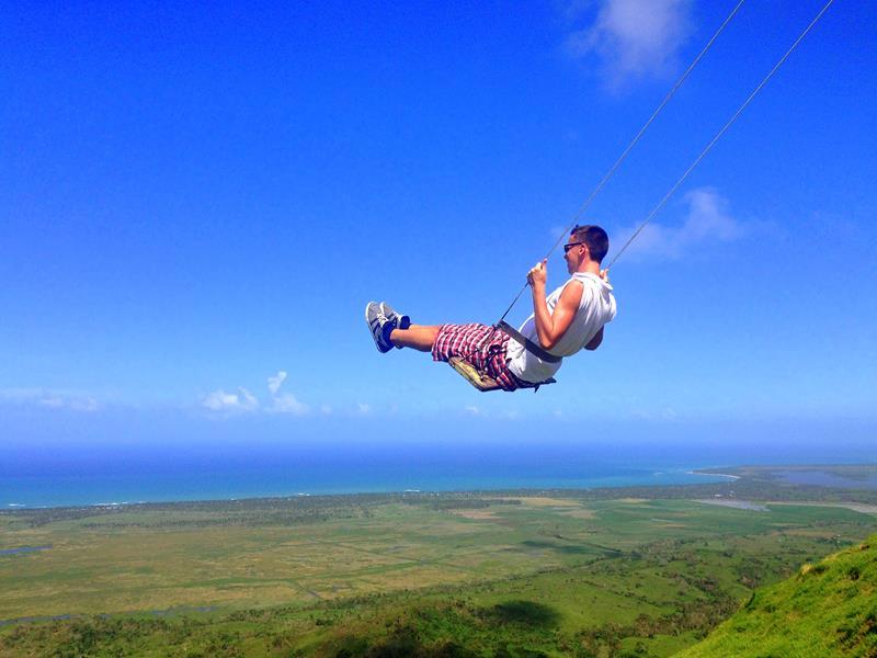 Chris on a swing high over the Dominican Republic landscape. Reasons to move to another country