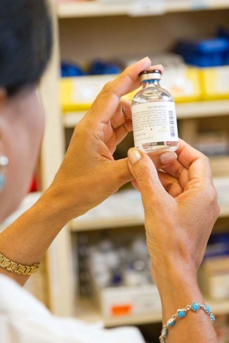 pharmacist looking at bottle