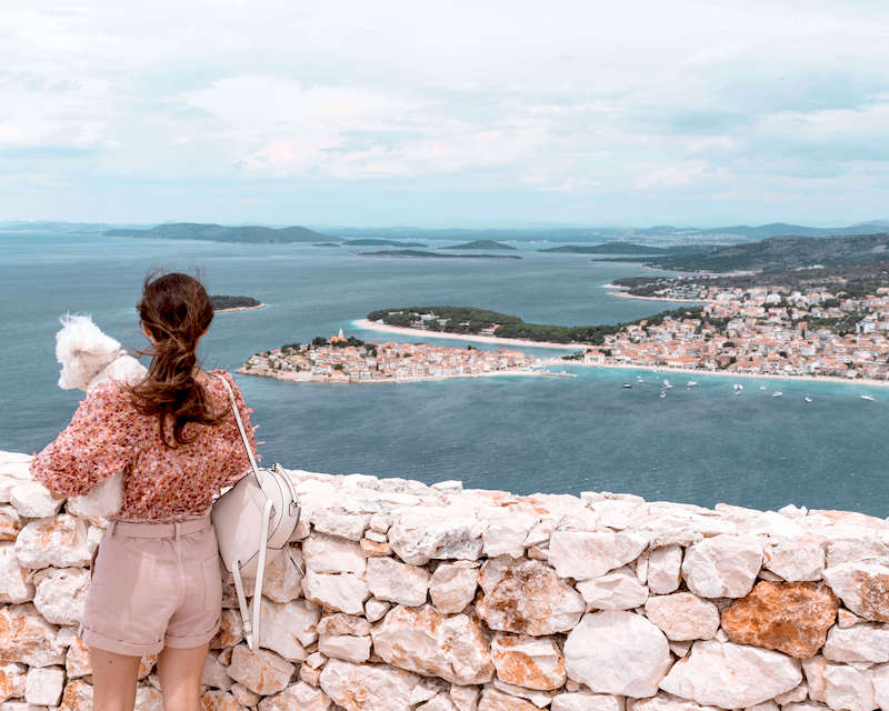 Olivia in shorts looking over the water and Dubrovnik