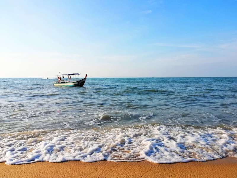 fishing boat near the shore of a beach