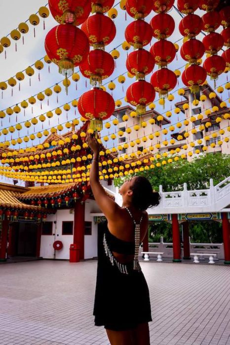 girl looking at red Chinese lanterns living in penang pros and cons