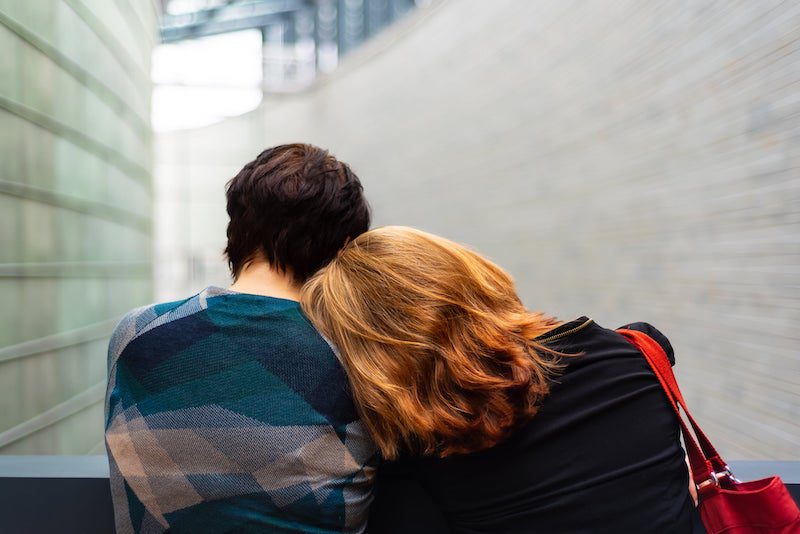 redhead leaning on partners shoulder