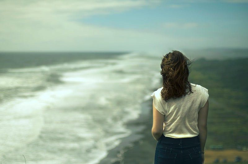 back of girl looking at the sea