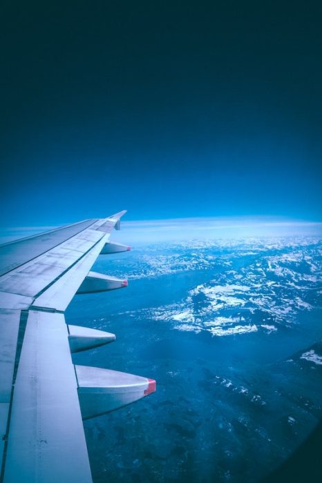 airplane wing over the earth