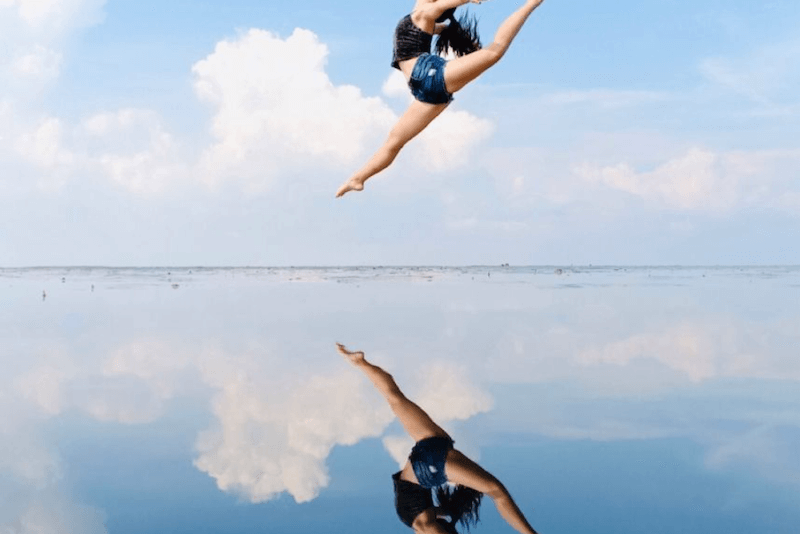 Girl jumping with reflection from Sky Mirror in Malaysia.