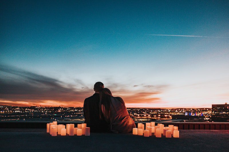 couple looking over skyline thinking about moving away from family