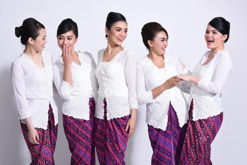 malaysian woman in white tops and batik skirts