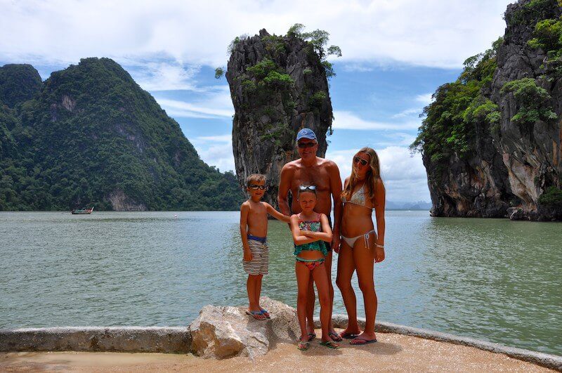 family in front of rocky outcrops in thailand