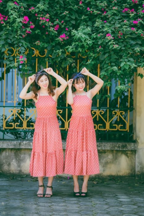Malaysian women wearing matching red polka dot dresses