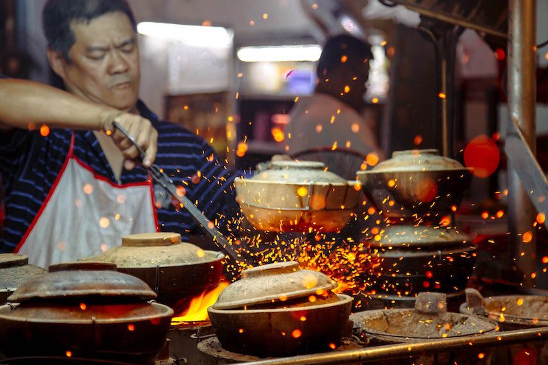 man cooking in malaysia