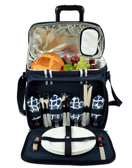 An open picnic basket full of food, plates, cutlery