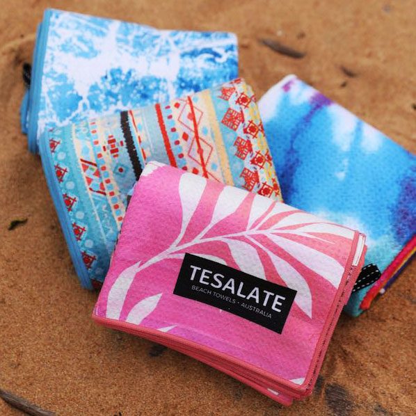 colorful folded towels make perfect gifts for the beach lover