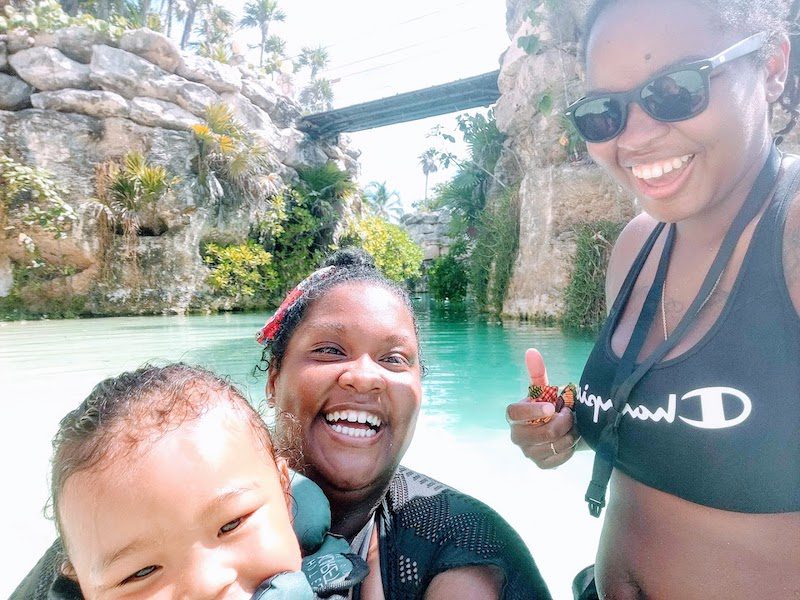 happy nomad family, 2 women and a kid in the water.  