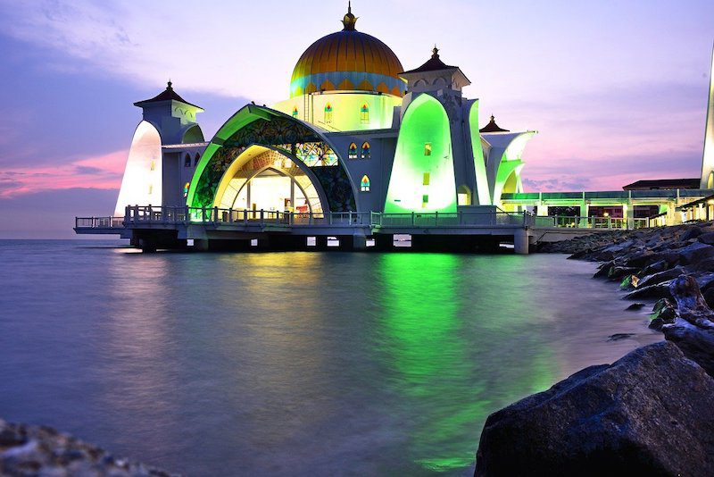 Melaka Straits Mosque looks like it's floating. It's all lit up with green glowing lights, its a must see sight on the what to do in Melaka list  