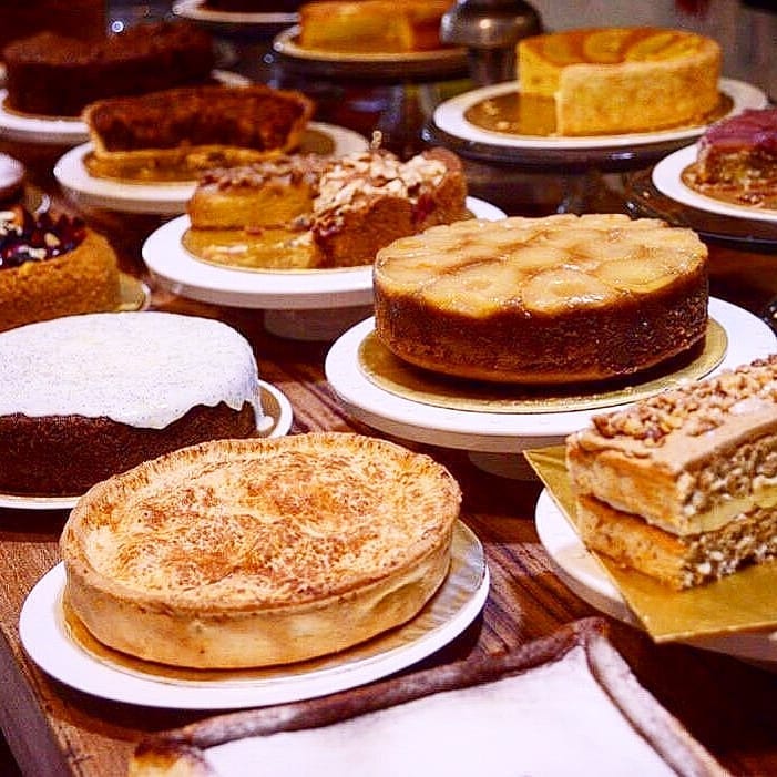 A famous Penang cafe's cake table full of treats