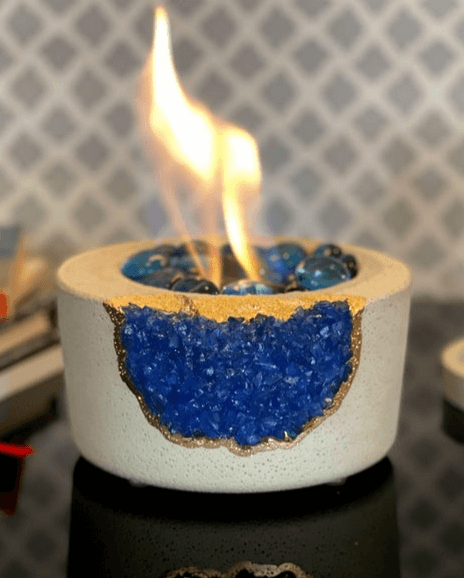 small round table top fireplace with blue crystals and a big flame a Unique Gift for Men Who Have Everything