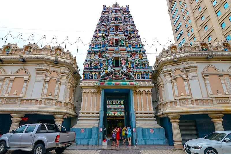 Hindu temple with colorful entrance and many sculpted deities. 