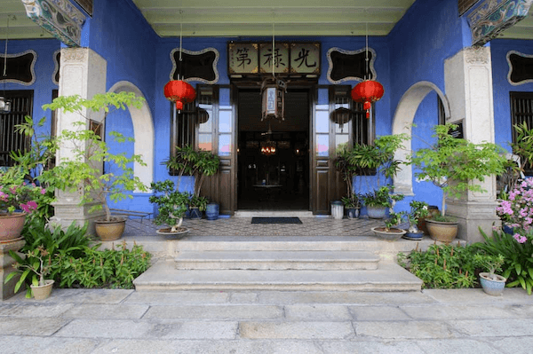 Blue hotel entrance with red lanterns at the Blue Mansion in Penang is one of the most historical places in Malaysia