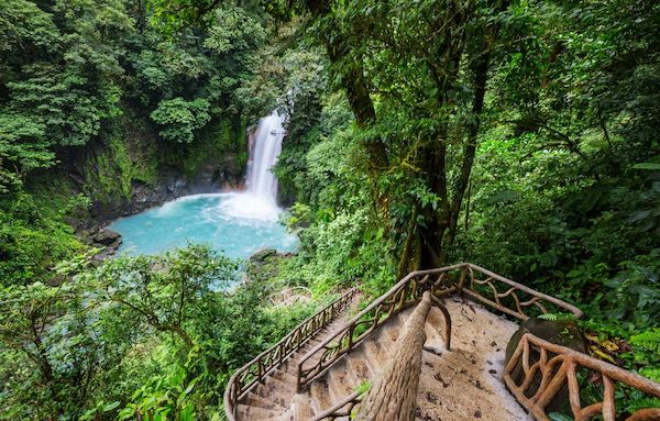a waterfall in Costa Rica surrounded by lush greenery. A perfect place for to get a digital nomad visa