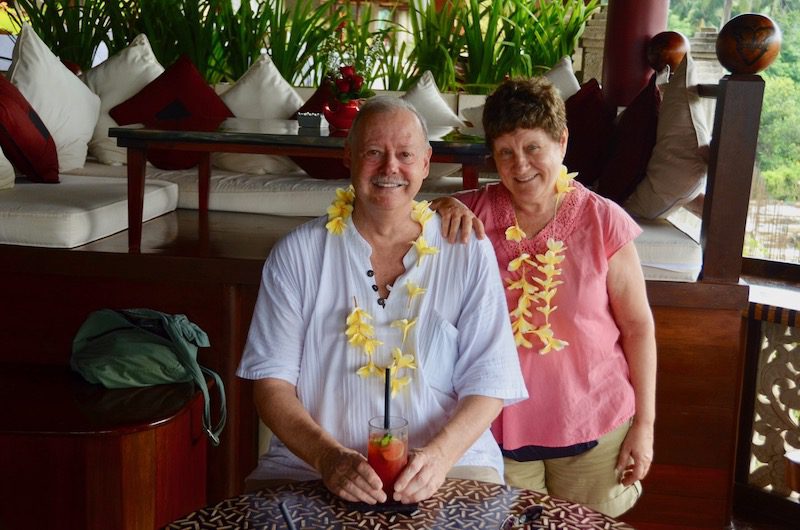 smiling couple wearing leis 