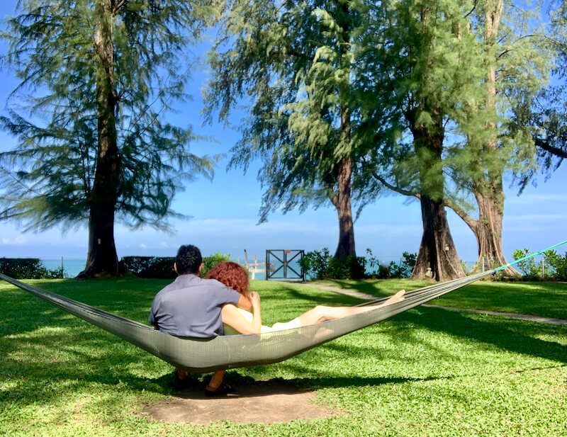 couple in hammock lookin at the ocean