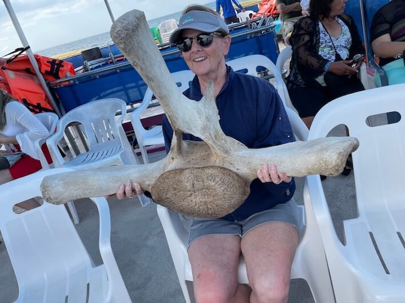 mom on whale watching tour holding a  whale vertebrae